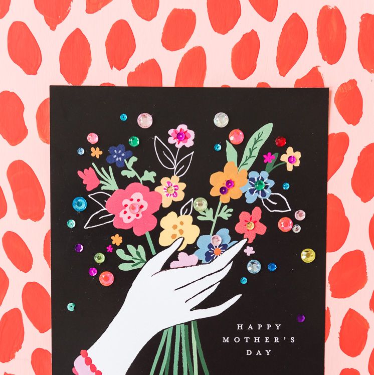 printable mothers day card with illustration of hand holding bouquet of colorful flowers on black background