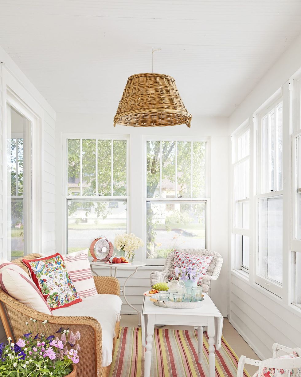 Sun porch with floral pillows and striped rug