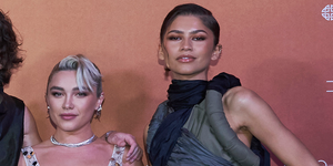 florence pugh and zendaya wearing crop tops and maxi skirts with thigh high slits to a 'dune part two' photocall