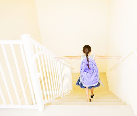 How to get the kids to school on time - girl with backpack walking down stairs at home