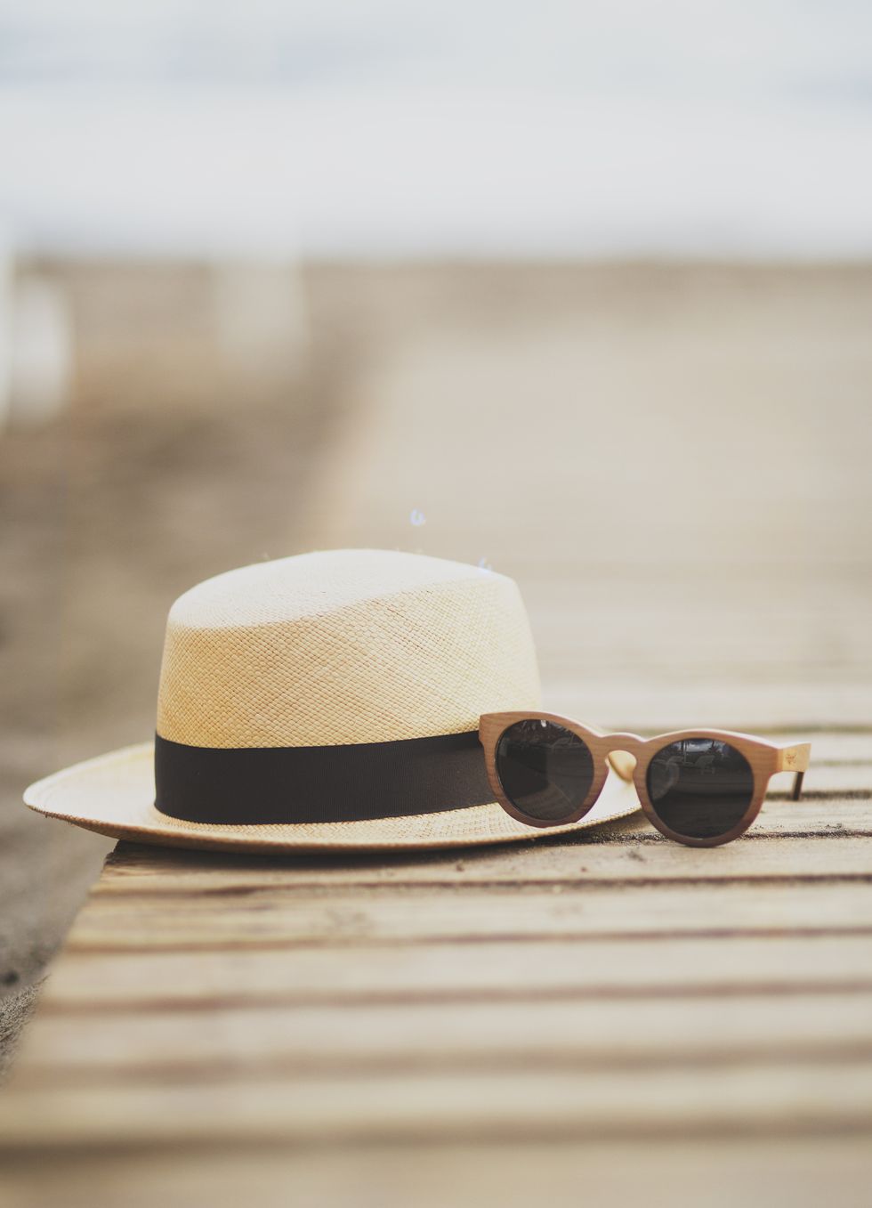 Straw hat and sunglasses on beach