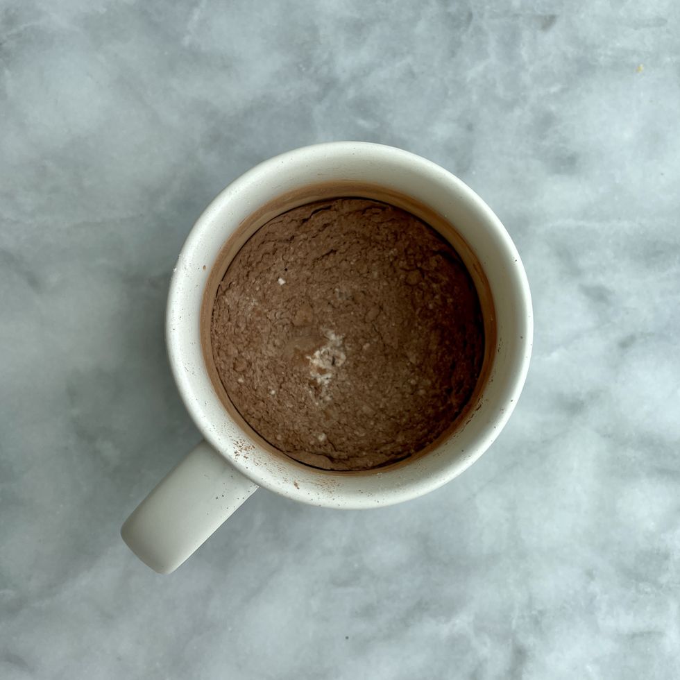 flour, cocoa powder and sugar in a cup for chocolate mug cake