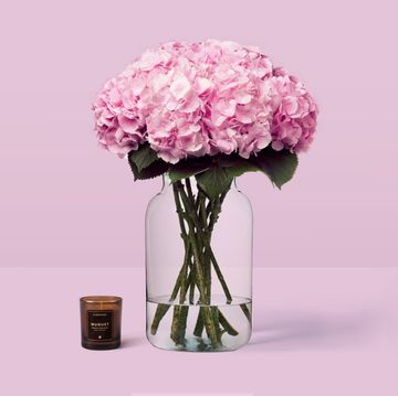 hydrangeas in a vase and a candle