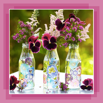 glass vases filled with flowers and decorated with decoupage