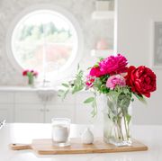 flowers in a white kitchen  with candle