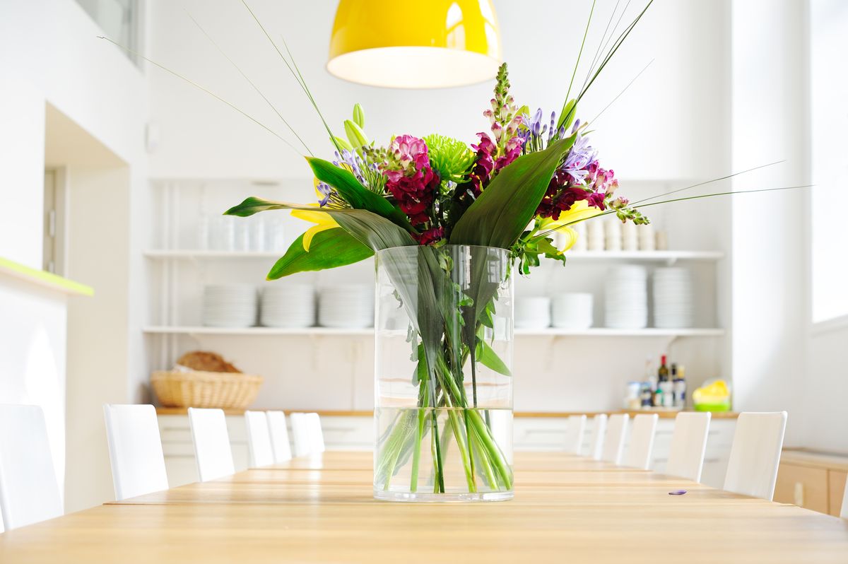 Flowers on table in bright large kitchen