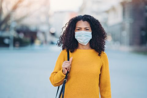 flu shot pros woman wearing a face mask walking outdoors