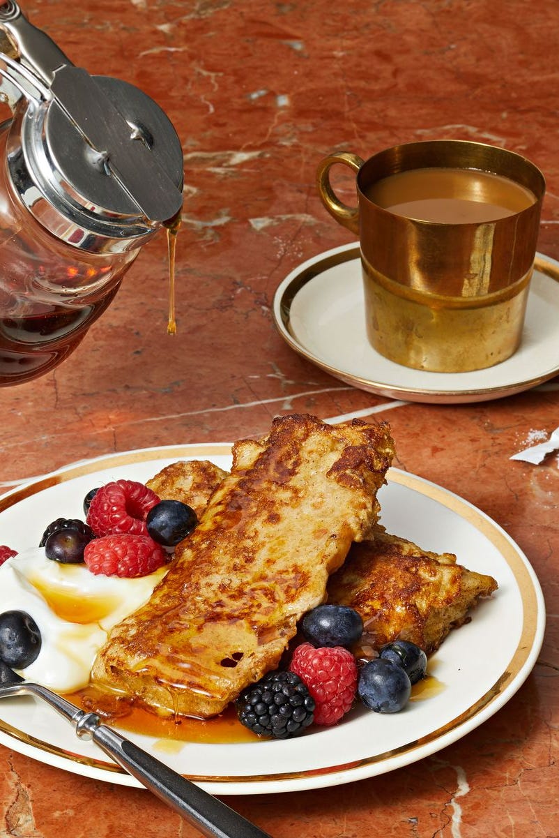 focaccia french toast with maple syrup, mixed berries and whipped cream on the side