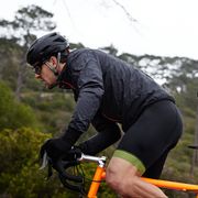 Focused, determined male cyclist cycling uphill