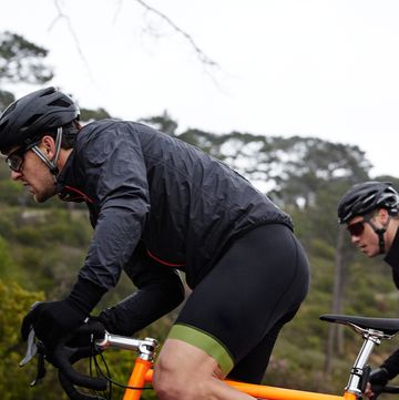Focused, determined male cyclist cycling uphill