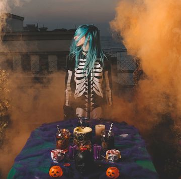 girl in skeleton costume at a foggy halloween party