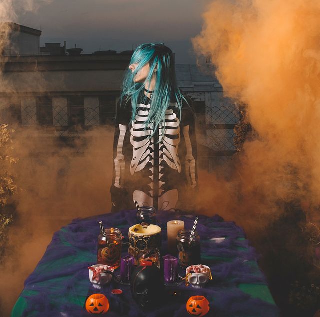 girl in skeleton costume at a foggy halloween party