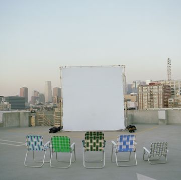 folding chairs sitting in front of projection screen on rooftop