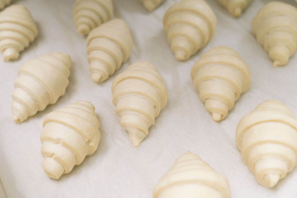 food background fresh homemade croissants close up shot of uncooked traditional french pastry ready to cook croissant