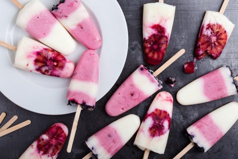 Food background.  Homemade berry yogurt ice pops with frozen black currant