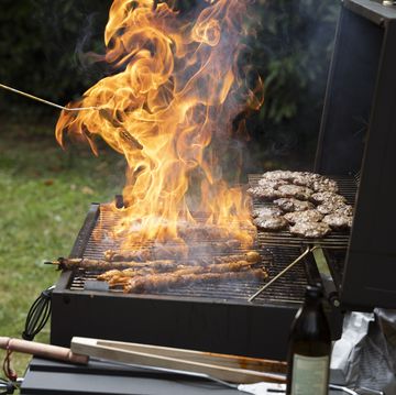 food burning on a barbecue in a back yard in summertime