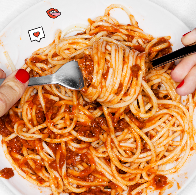 a person with red nails eating a bowl of spaghetti with meat sauce