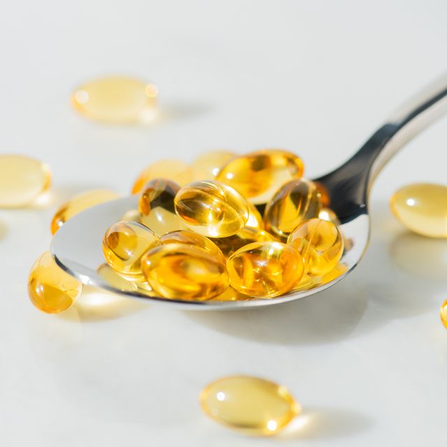 food supplement omega 3 in a spoon, medical supplements and vitamins d