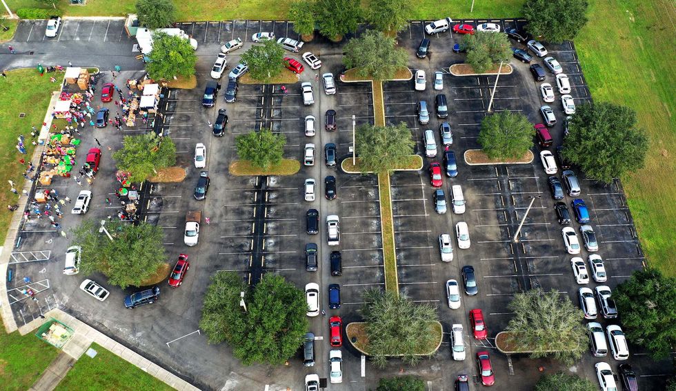clermont, florida, united states   20201121 editors note image taken with droneresidents line up in their cars at a food distribution site at lake sumter state college sponsored by the second harvest food bank of central florida and local churcheswith the approach of thanksgiving, thousands of families in the orlando area are in need of food assistance due to covid 19 related layoffs in the tourist industry and the expiration of supplemental federal unemployment benefits photo by paul hennessysopa imageslightrocket via getty images