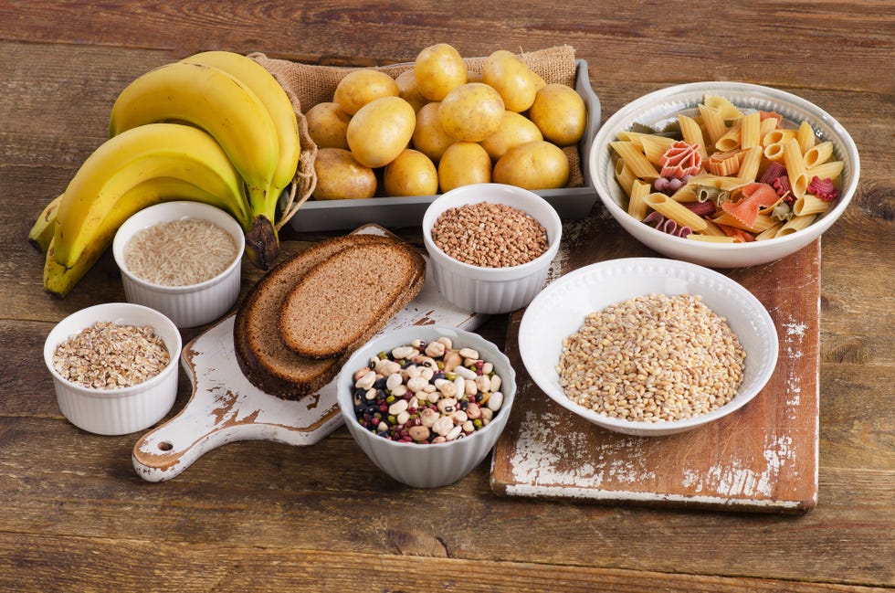 Foods high in carbohydrate on wooden background.