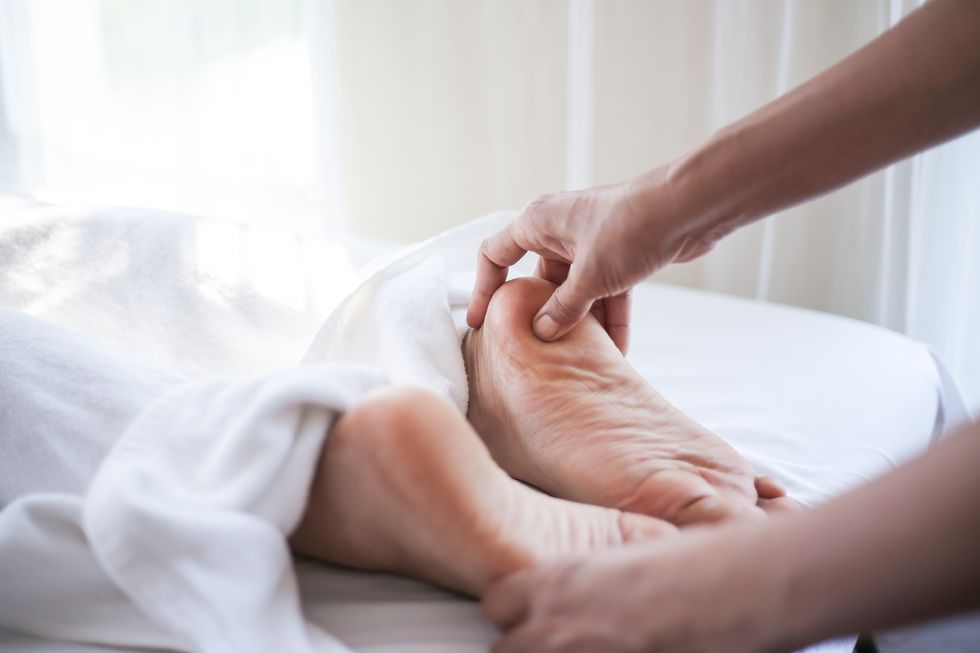 foot massage in spa salon, closeup