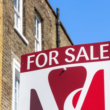 for sale property agency sign posted outside english terraced houses in poplar, east london