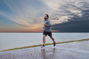 runner running by water wearing garmin forerunner 245 music