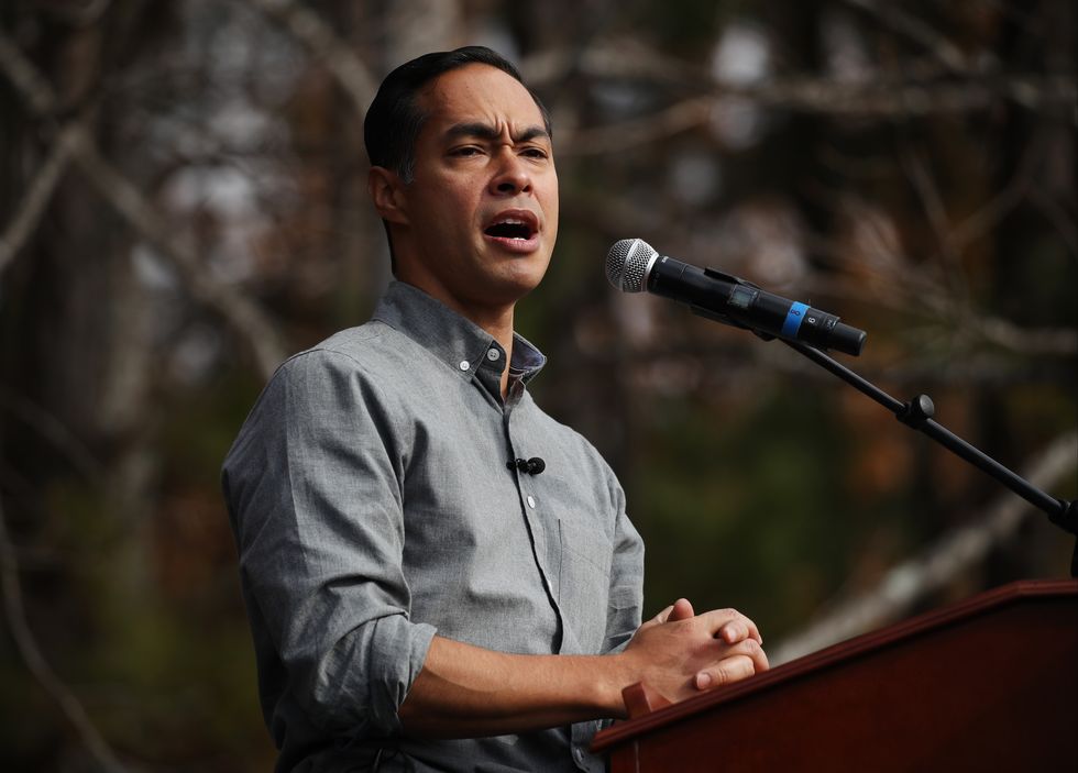 julian castro standing at a podium and microphone and speaking at a political rally