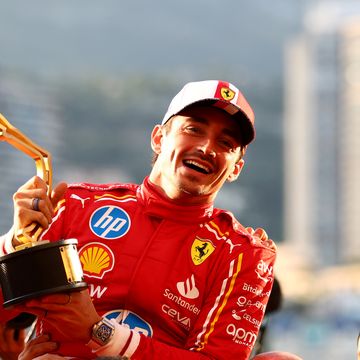 formula 1 driver charles leclerc holds his winner's trophy and laughs as his teammates lift him up on their shoulders
