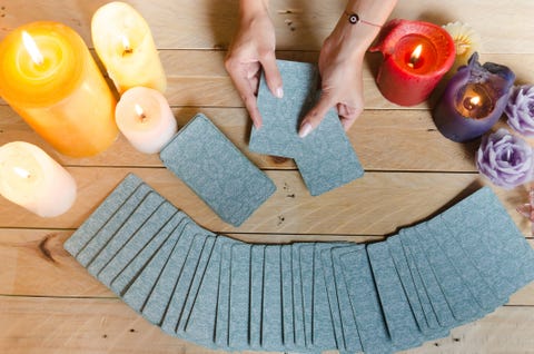 fortune teller female hands and tarot cards on wooden table