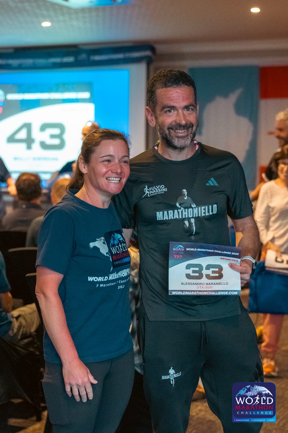 participants at a marathon event with race bibs and shirts displaying branding