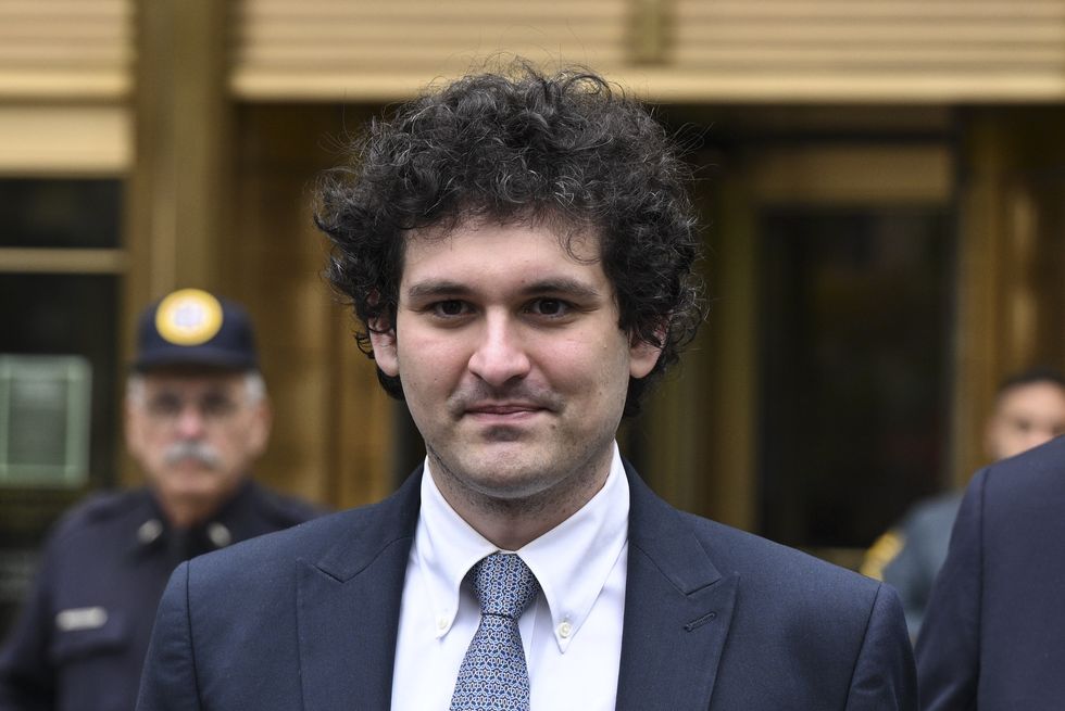 man wearing a suit and tie and smiling at a court appearance