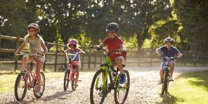 how to buy and size a kids bike four children on cycle ride in countryside together