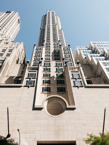 a tall skyscraper viewed from below showcasing its architectural design