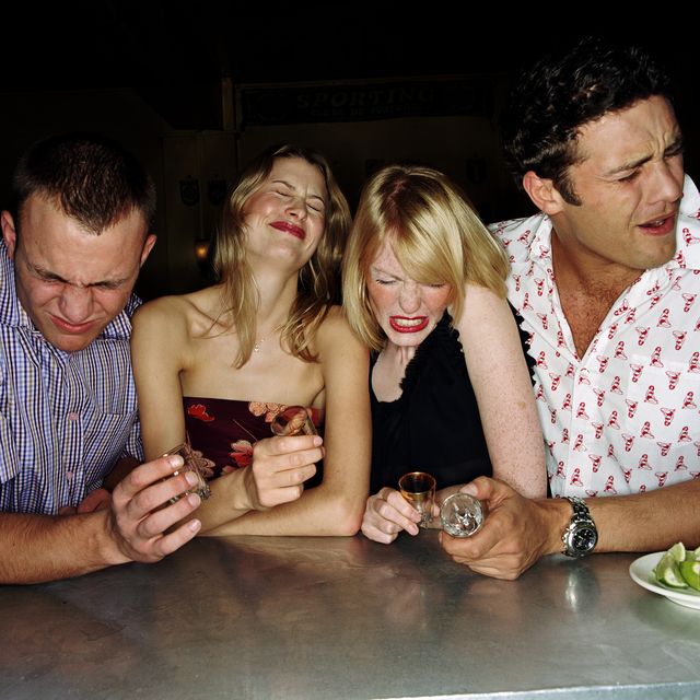 four young friends drinking tequilla shots