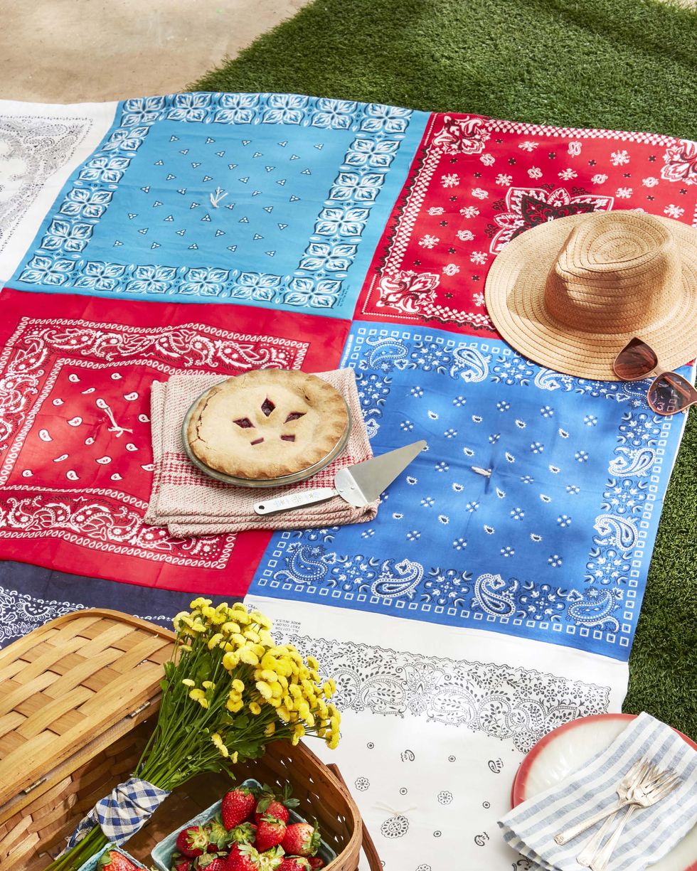 a picnic blanket made from red, white, and blue bandanas