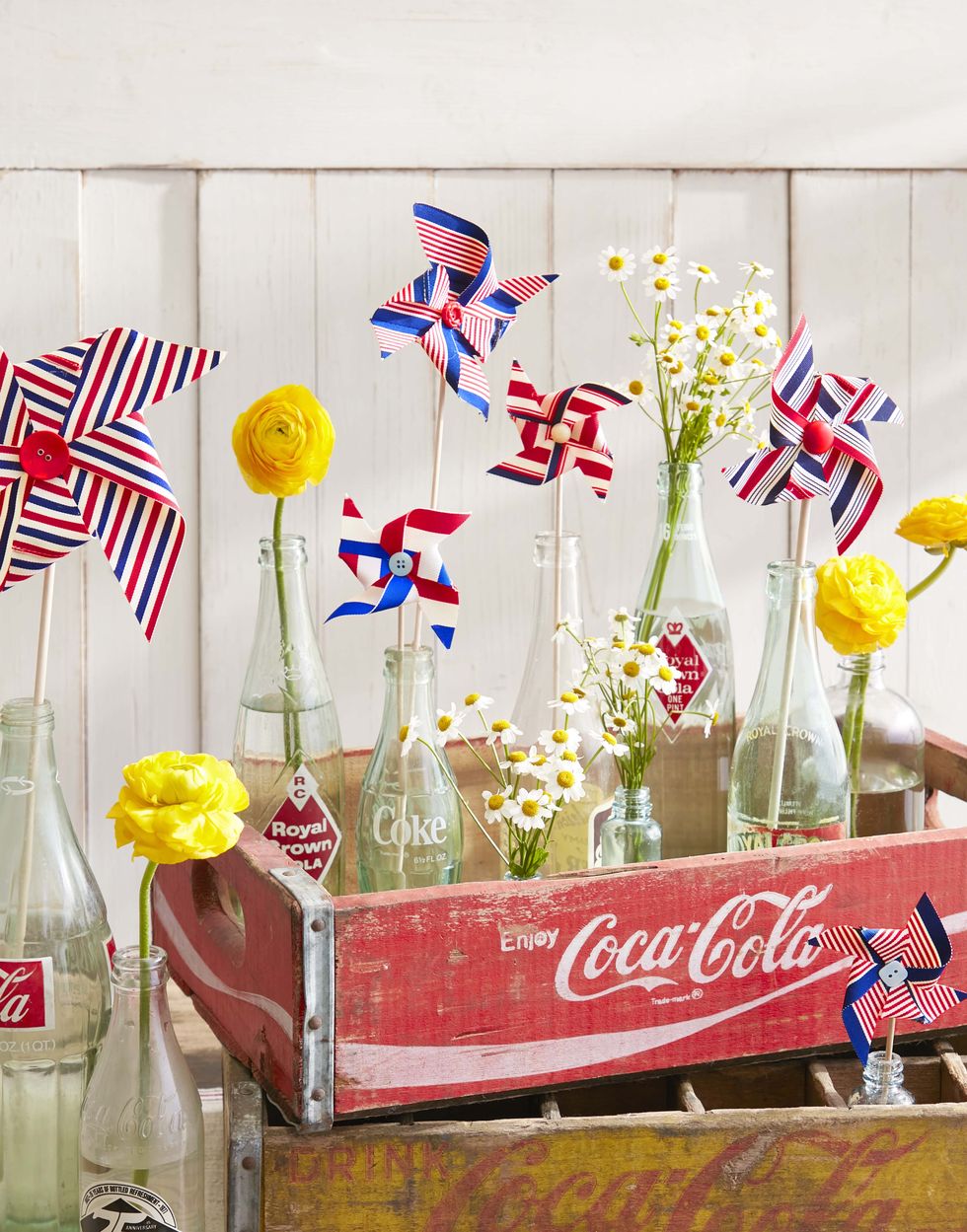 pinwheels made from red white and blue ribbons with button centers attached to skewers