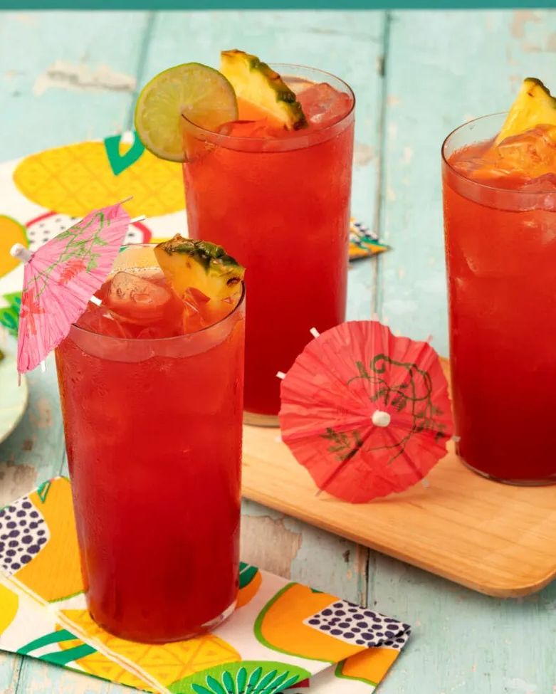 bay breeze cocktail with paper umbrellas and pineapple wedge