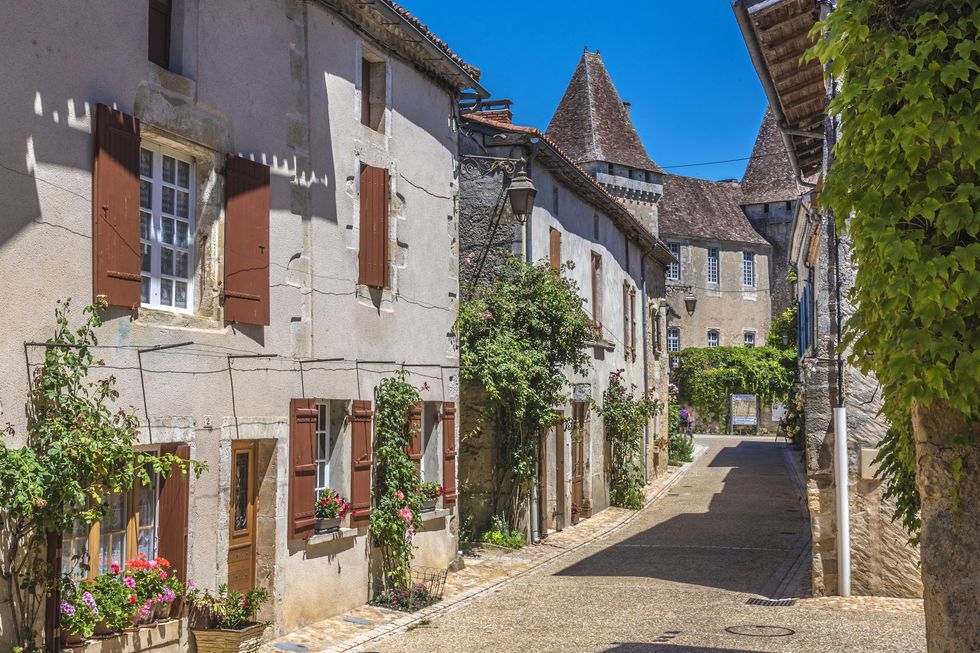 france, dordogne, perigord vert, saint jean de cole plus beau village de france most beautiful village in france, peasant houses with flowers along the street