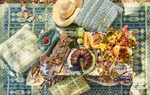 a blockprint tablecloth on the ground covered with a beautiful picnic