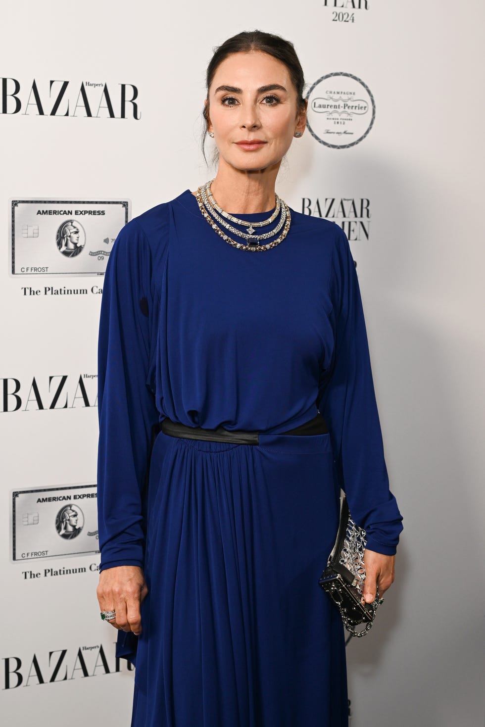 fashion event with a person in a blue dress and layered necklaces