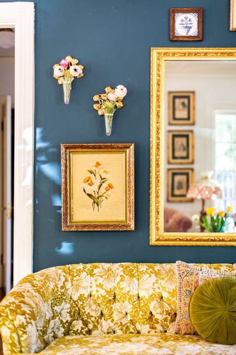 wall with mirror and framed floral art