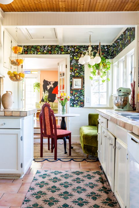 kitchen with patterned rug and floral wallpaper