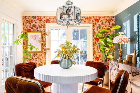 dining room with velvet chairs and floral wallpaper