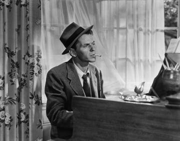 in a classic pose, frank sinatra smokes a cigarette as he plays piano in the movie young at heart one of the movies songs became a trademark saloon song for sinatra make it one for my baby and one more for the road, by harold arlen and johnny mercer