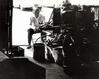 this photograph showing frank deep in thought and looking at the prototype shown in 63rjp003 while it is in the shop  this was his usual mode of trying to improve on the last tests performed  while he was poor at drafting, frank would normally scribble something on the floor with a piece of soapstone that would tell  what he wanted changed prior to the next trial run