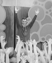 Fred Rogers of Mister Rogers' Neighborhood entertains children during a Mister Rogers' Day celebration