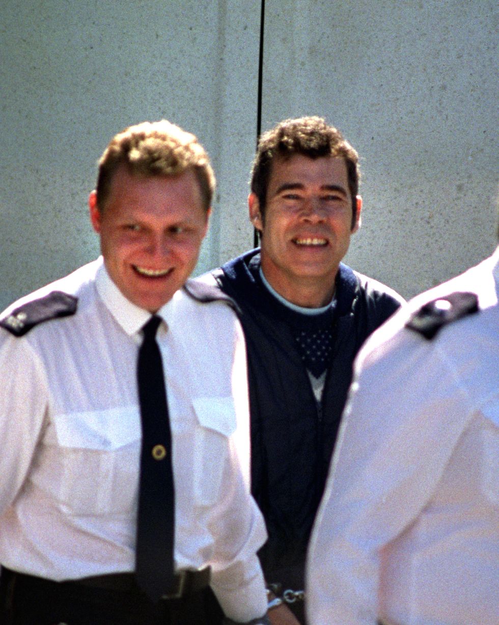 Fred West handcuffed to prison guards