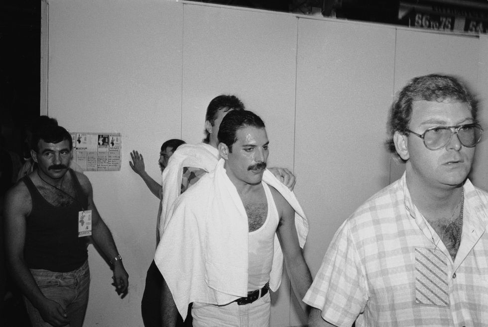 Freddie Mercury backstage at the Live Aid concert in July 1985. On the left is his boyfriend Jim Hutton.