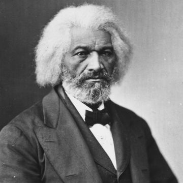 frederick douglass posing for camera in a suit